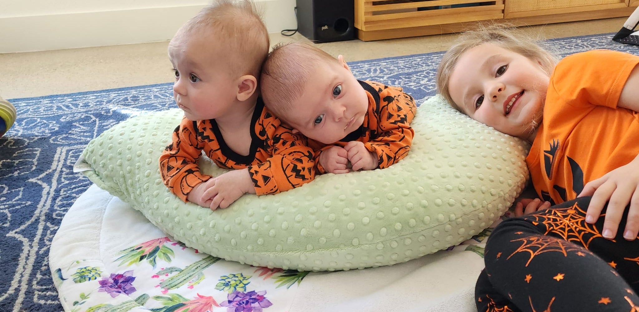 Babies using luna lullaby nursing pillow as a tummy time support