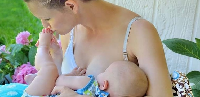 Mother using V shaped plush nursing pillow cover