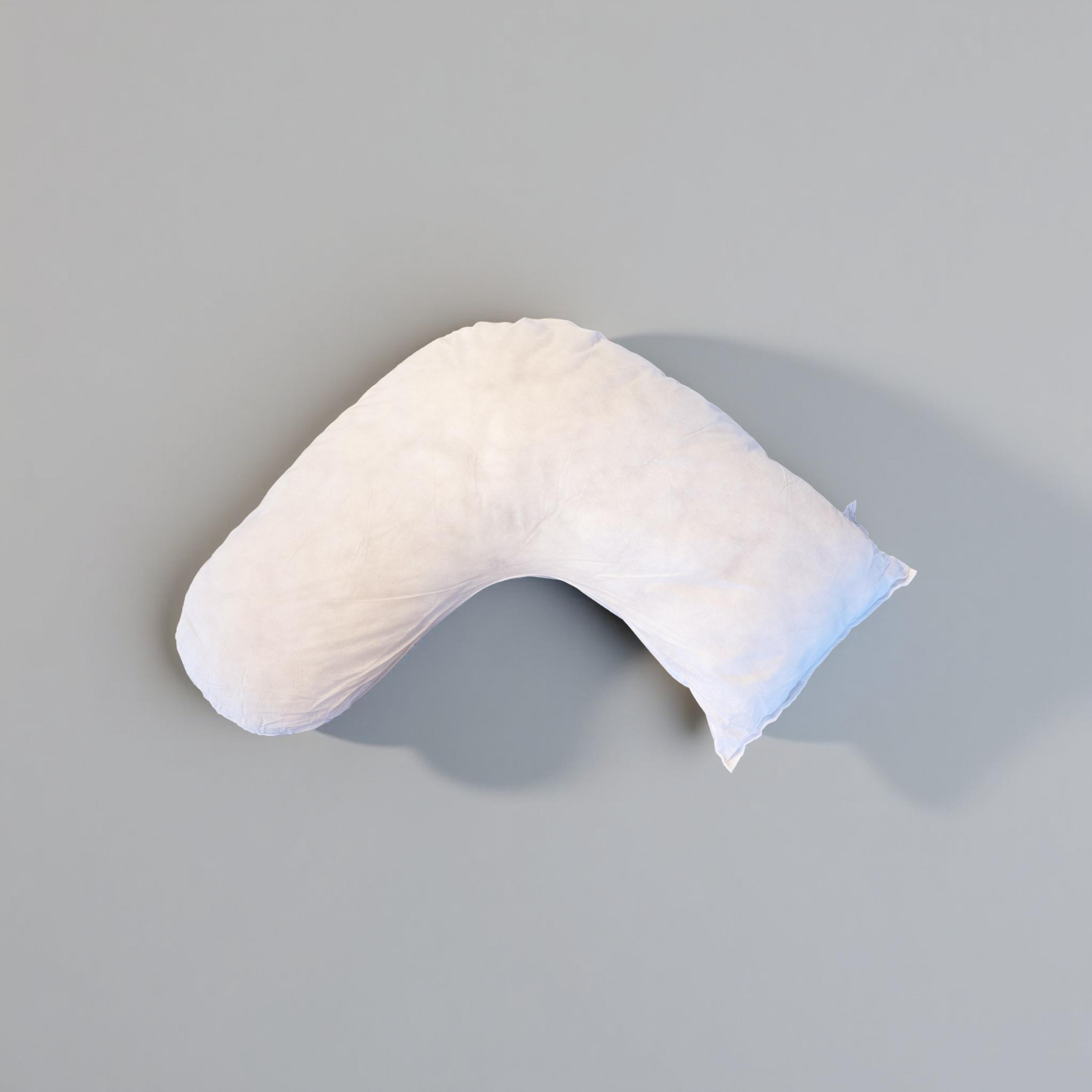 Luna Lullaby A beige, V-shaped nursing pillow on a grey background.