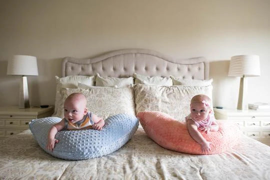 Twin babies on Luna Lullaby nursing pillow